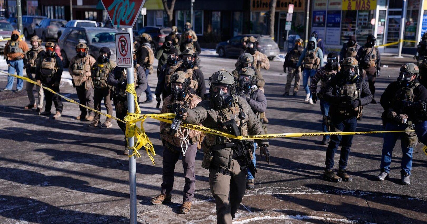 Officers react with crowd after man was killed in Minneapolis amid immigration crackdown , in photos