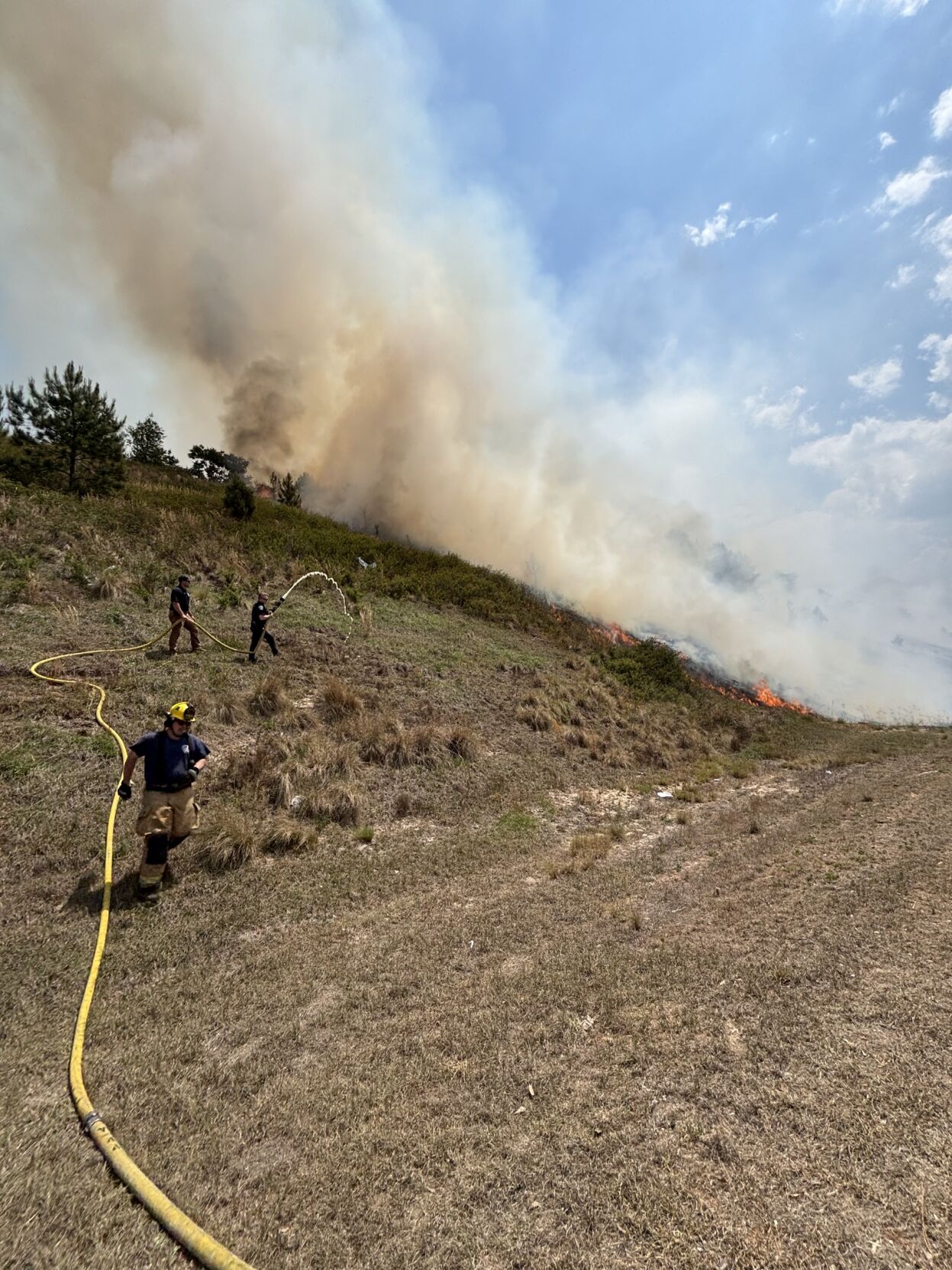 Multiple crews battle large brush fire on I-520, schools dismiss early ...