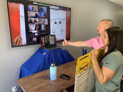Founders of “Family Initiative” David Brown and Anjali Van Drie teach their group how to draw Baby Yoda over video chat. (WINK News)