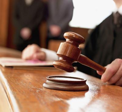 Close up of judge raising gavel in courtroom