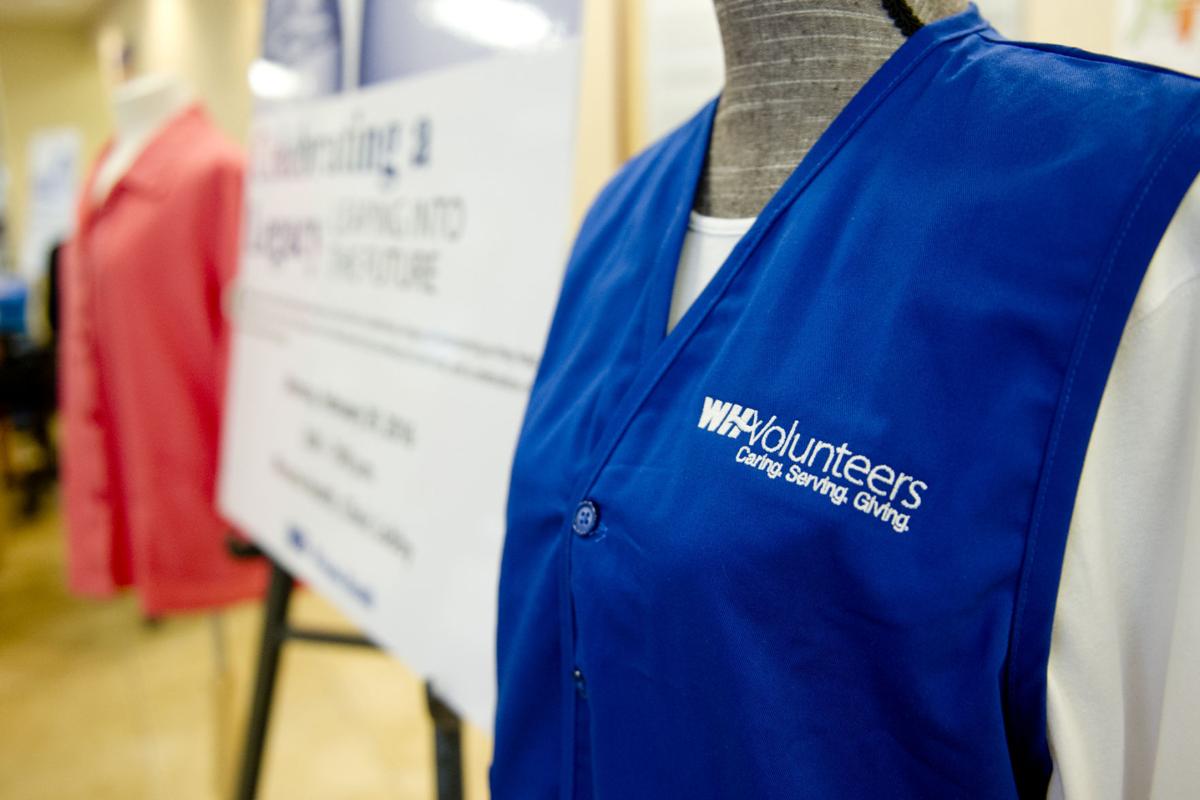 Hanging up their pink smocks Bluevested Winona Health Volunteers take
