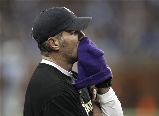 Brett Favre walks the sideline as a member of the Atlanta Falcons