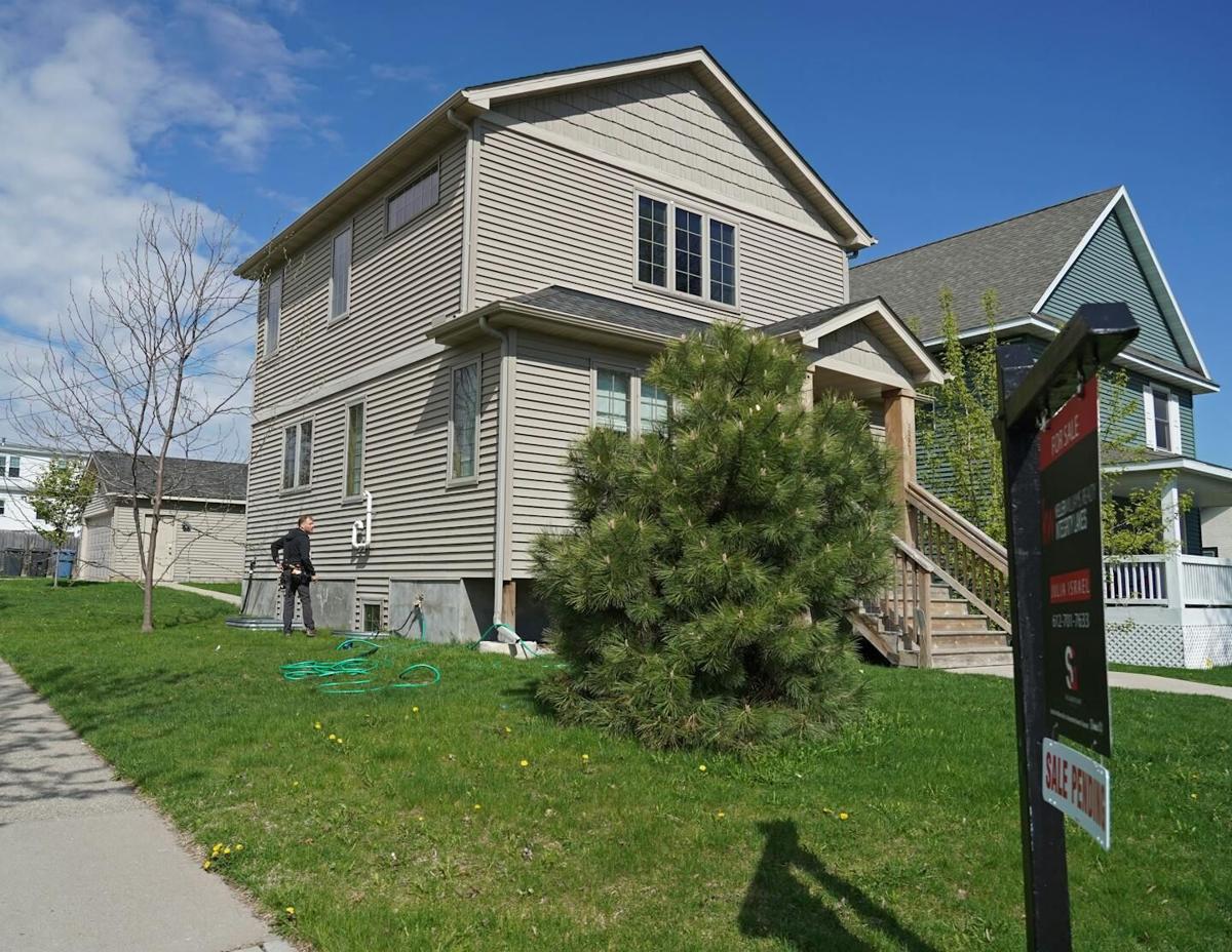 In this 2019 photo, a Structure Tech certified home inspector Bryan Scholtes looks over a Minneapolis home after its purchase. Purchase cancellations, which can stem from maintenance issues turned up during inspections, are on the rise.
