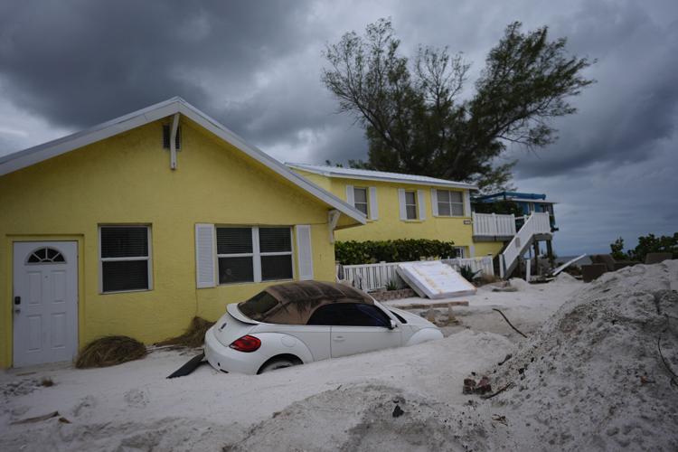 Storm surges bury Florida towns in mountains of sand
