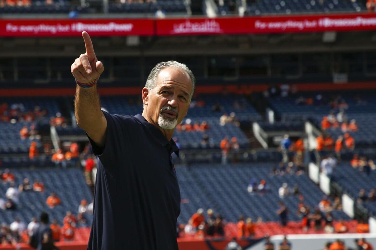 In this file photo from 2019, defensive coordinator Chuck Pagano points to Bears fans during warmups before a game against the Denver Broncos in Denver.