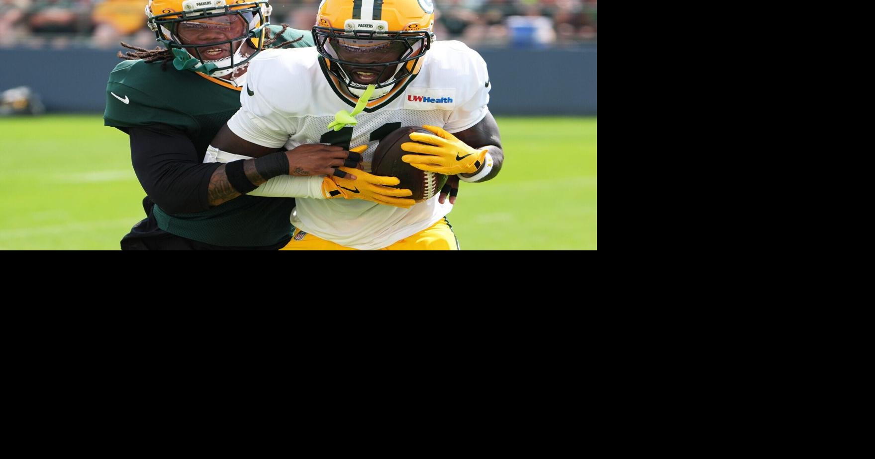 Green Bay Packers nickel cornerback Javon Bullard tries to tackle wide receiver Jayden Reed during the sixth day of training camp.