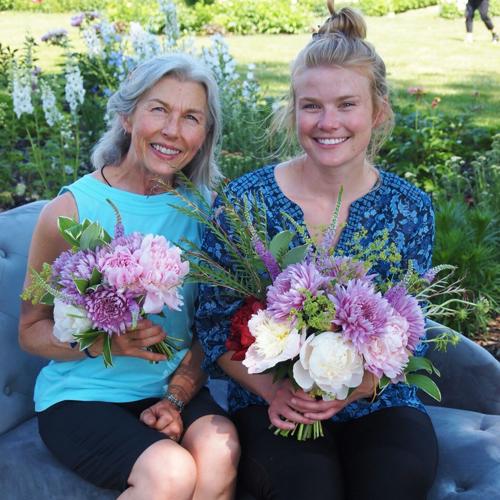 Two ladies sitting with bouquets.png