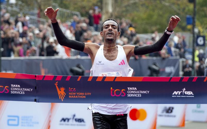 Tola sets NYC Marathon course record to win men's race; Obiri takes