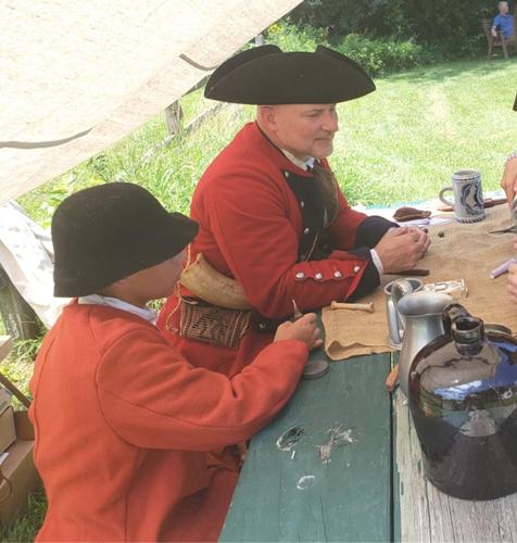 Living history demonstrator Rick Siedemann shares hands-on skills with youth at a past Historic Indian Agency House event.