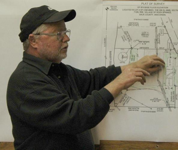 Terry Geyman points at map