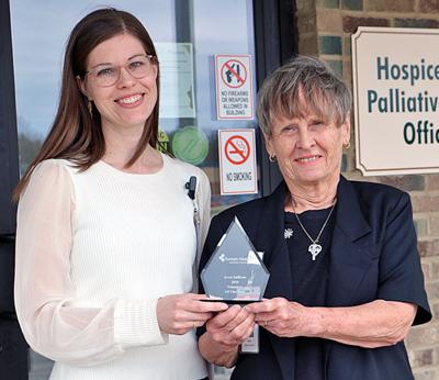 Tomah Health Hospice Touch/Palliative Care volunteer specialist Beth Shetter, left, presents a plaque to Arris Sullivan as the organization’s volunteer of the year for 2026 on April 24.
