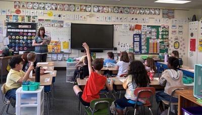 Susan DeVoe, Prevail Bank relationship banker, facilitates money saving activities in Lynette Mattice’s second grade classroom on April 23 at Gordon L. Willson Elementary School.