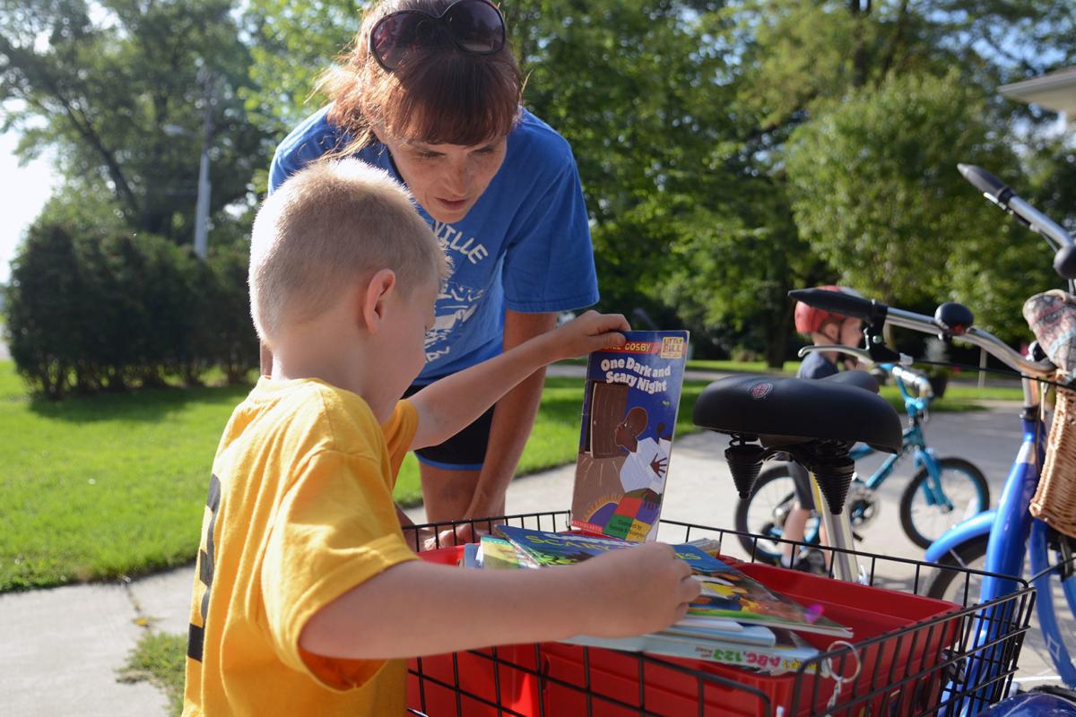 'Book fairy' bikes around Pardeeville sharing books with children