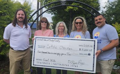 Catholic Charities representatives, from left, Matthew Scott, Sue Howland and Tracey Denny, accept a $5,384.61 grant from United Way of Dodge County representatives, Tammy Appel and Bryce Remy on June 25.