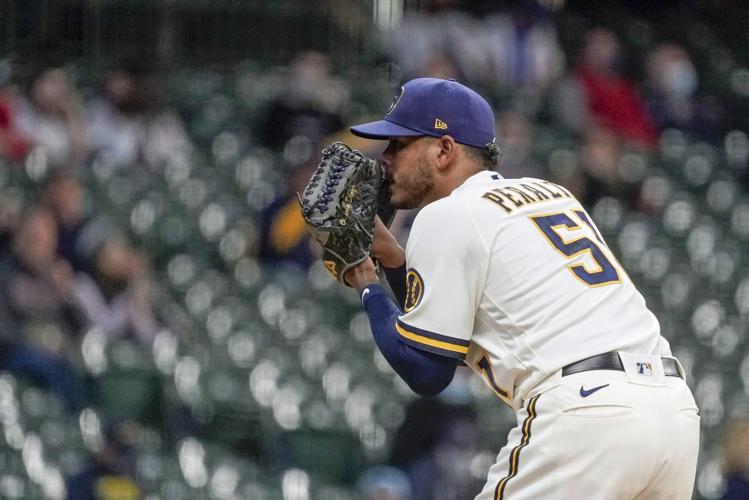Houser homers, strikes out 10 to make Brewers history in win over