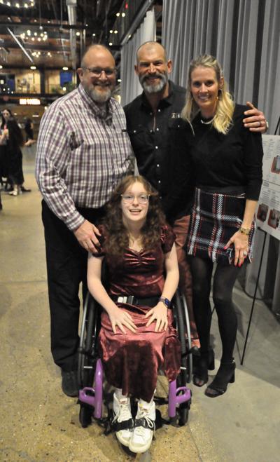Camp Wawbeek camper and Eau Claire resident Mari McHenry, her father Chris and event emcee Joe Thomas of Hall of Fame Farms and his wife Annie at the Easterseals campaign fundraiser held March 12.