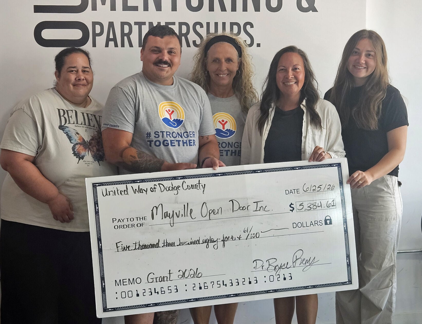 United Way of Dodge County representatives, from left, Trisha Bradley, Bryce Remy, Tammy Appel, present Open Door Coffee Shop representatives, Amber Schraufnagel and Samantha Manke, a $5,384.61 grant to help sustain programs that provide counseling services, after-school tutoring and connection.