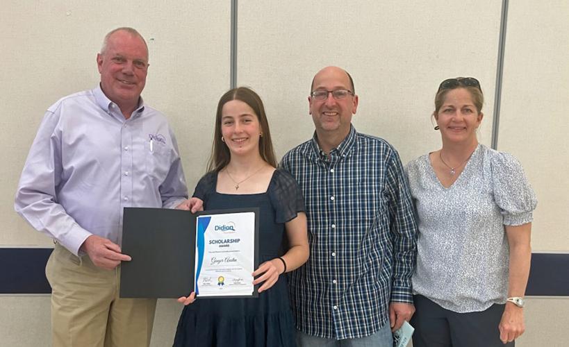 From left, Jim Hepp, representing Didion, presents a $5,000 scholarship to Ginger Austin with her parents Matt and Karen Austin at the Markesan High School awards night on May 13.