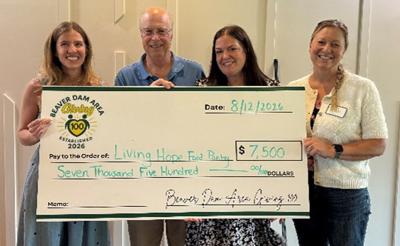 Giving 100 awards a $7,500 grant to the Living Hope Food Pantry, Fox Lake, on Aug. 12. From left, Melanie Budde, Jim Nabak, Libby Loomans, Nikki Poetter.