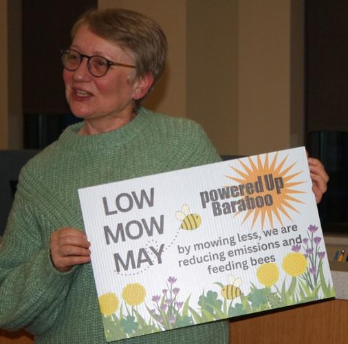 Nissley holds Low Mow May sign