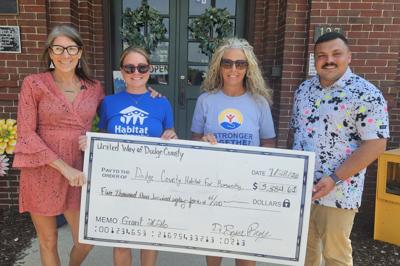From left, representatives from Habitat for Humanity of Washington and Dodge Counties, Megan Camin, and Amber Ruch; accept a $5,384.61 donation from United Way of Dodge County representatives, Tammy Appel and Bryce Remy on July 28.