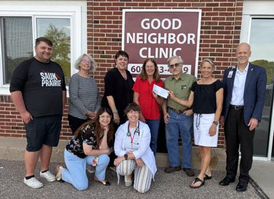 Sauk Prairie Healthcare Foundation presents a $4,325 donation to the Good Neighbor Clinic Board of Directors, proceeds from the fourth annual Good Neighbor Ride on May 19. From front, left, Veronica Gallas, Agnes Kanikula; back row, Kohler Olszewski, Terri Broxmeyer, Susan Baumann-Duren, Lisa Pickarts, Dr. Eric Hamburg, Dr. Maribeth Baker, Todd Wuerger.