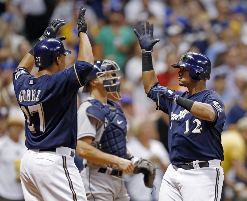 Carlos Gomez of the Milwaukee Brewers makes a catch at the wall