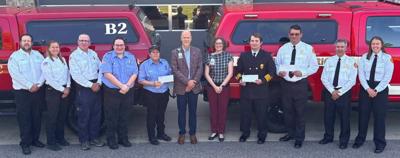 Sauk Prairie Healthcare Foundation presents $600 checks to three fire departments to purchase gear bags and patient lifters on May 27. From left, Ryan Mussack, Sauk Prairie EMS; Kelli Kirch, SP EMS; Dean Darling, SP EMS; Bailee Muth, Merrimac Fire & Rescue; Shelli Muth, MFR; Todd Wuerger, Sauk Prairie Healthcare; Belle Koch, SPH; Dylan Shaker, Prairie du Sac Fire Department; Jim Pugh, Sauk City Fire Department; Dan Ederer, SSCFD; McKenzie Pugh, SCFD.