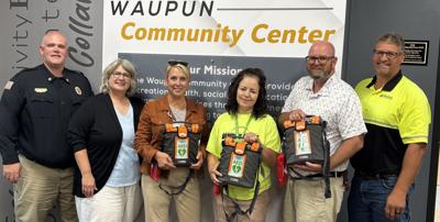 Deb Winterhack, Agnesian HealthCare Foundation director of development, third from left, with city of Waupun leaders, from left, DJ DeMaa, fire chief; Kathy Schlieve, city administrator/director of Economic Development; Kim DeBoer, Waupun Community Center; Rohn Bishop, mayor; and Jeff Daane, director of Public Works, after presenting accessible automated external defibrillators that will be available to individuals who utilize programs or services at three city of Waupun locations, according to an Aug. 3 release.