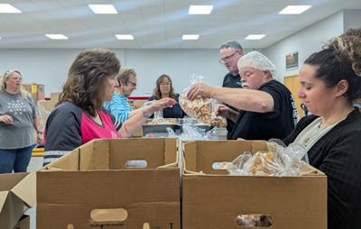 Beyond Blessed Pantry and Prevail Bank staff and volunteers, from left, Shannon Howley, Sue Devoe, Kristi Anderson, Janet Diaz, Craig Philipp, Mike Althen, Tara Mangino, on June 19.