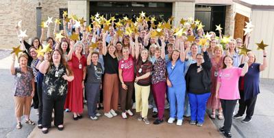 Reedsburg Area Medical Center staff holding up stars in celebration of being recognized as a five-star facility, on June 30.