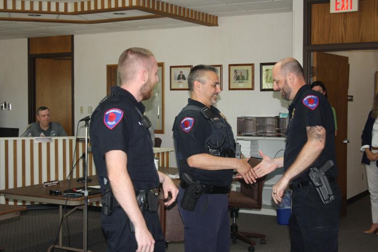 Brinker shakes hands with officers