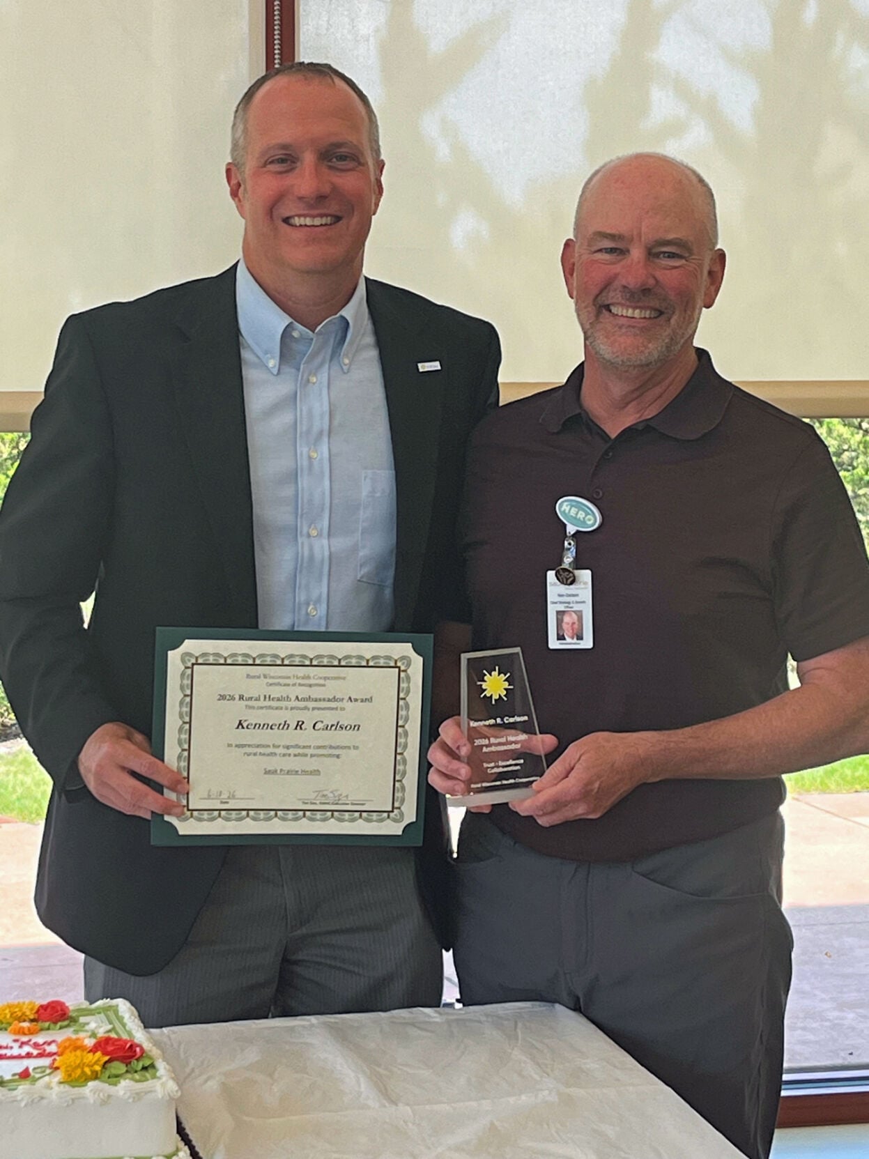 Ken Carlson, chief strategy & growth officer at Sauk Prairie Healthcare, right, receives the Rural Wisconsin Health Cooperative 2026 Rural Health Ambassador Award from Jeremy Levin, director of advocacy for RWHC, according to a July 20 release.