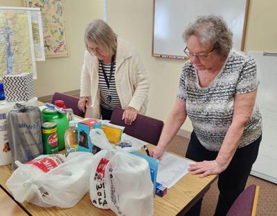 Marian Krueger, left, and Marcia Eckmayer, prepare orders for the April 28 Personal Essentials Pantry distribution where more than 100 families benefit from the group’s efforts.