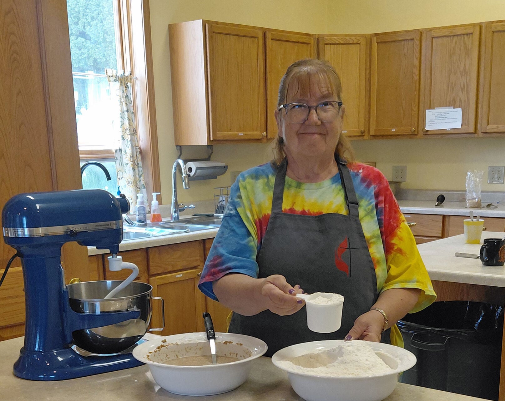 Char Collins mixing bread dough as part of the Friends in the Pantry group classes.