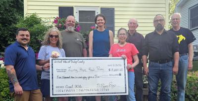 From left, Bryce Remy and Tammy Appel, United Way of Dodge County; presents Living Hope Food Pantry representatives, Steven Katsma, Joelle Baehr, Jill Benson, Bob Bergmann, Mason Zantow, and Jim Nabak a $5,384.61 donation on June 3.