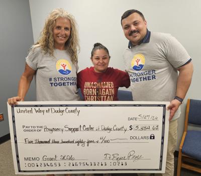 Dodge County United Way representatives, Tammy Appel, left, and Bryce Remy, right, present a $5384.61 grant to Nancy Villegas, Pregnancy Support Center on May 27.