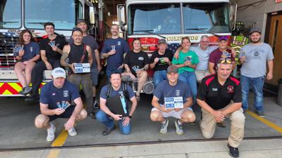 Some members of the Columbus Fire Department display the DripDrop drink packets awarded from National Volunteer Fire Council during the Aug. 11 training exercise.