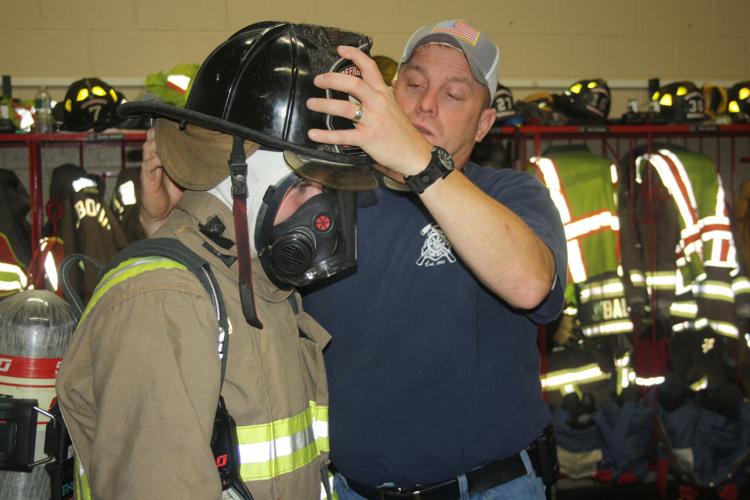 Swansbys work with fire helmet