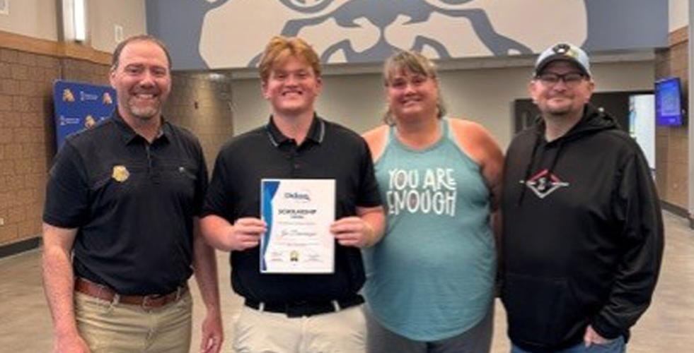 From left, Garry Gard, representing Didion, presents a $5,000 scholarship to Joe Dosemagen with his parents Kaye and Darren Dosemagen at the Pardeeville High School awards night on May 13.