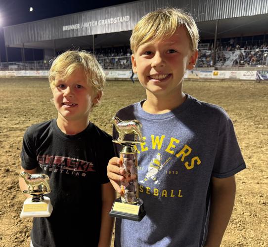 Parents, Seth and Tiffany Evans of Green Bay, were in town visiting family in time for their children Mason, right, and Cameron to participate in the Mutton Bustin’ competition at the Juneau County Fair Rodeo on Wednesday. Mason won the competition.