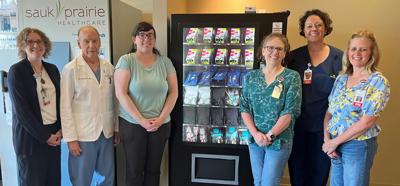 Sauk Prairie Healthcare and Public Health Sauk County collaborated on the installation of a public health vending machine in the vestibule of Sauk Prairie Hospital’s Emergency Department, according to a June 26 release. From left, Belle Koch and Dr. John McAuliffe from SPH; Hannah Erdman of PHSC; Ann Moran, Susan Thering and Shabvon Johnson of SPH.