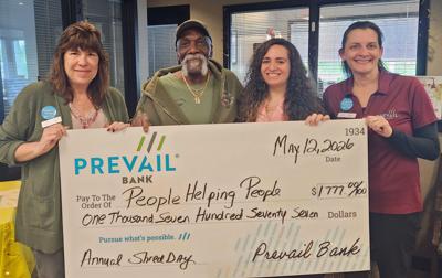 Bill Harris, People Helping People’s president, second from left, accepts a $1,777 donation from Prevail Bank professionals, from left, Susan DeVoe, Tara Mangino, and Brooke Peterson. Prevail Bank contributed $1,000 and the public donated the balance during the Shred Day event held May 12.