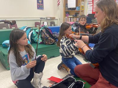 BD students learn to play the violin