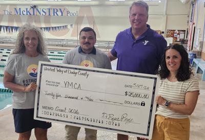 United Way of Dodge County representatives, from left, Tammy Appel and Bryce Remy, present a $25,000 grant to YMCA of Dodge County representatives, Dirk Langfoss and Ellie Moore on May 27.