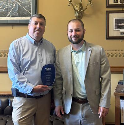 Rep. Mark Born, left, receives a Wisconsin Counties Association Outstanding Legislator Award on July 1 from WCA Government Affairs associate Collin Driscoll.