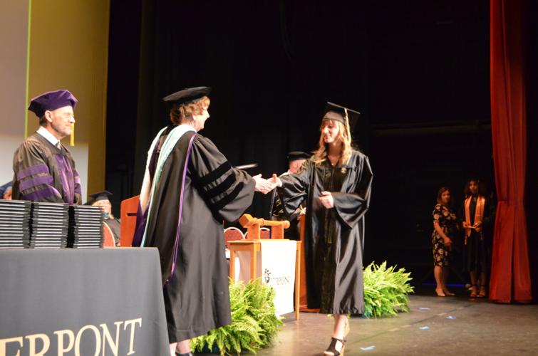 Nelson handing off diploma