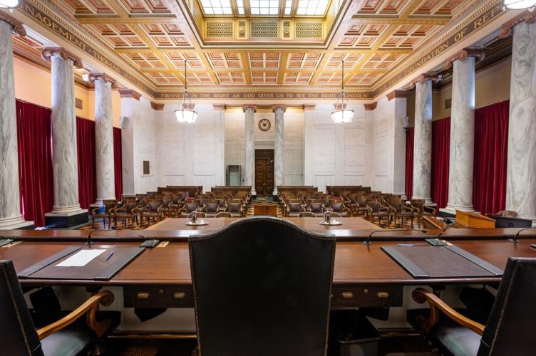 In the background: Several lawyers help West Virginia justices as they