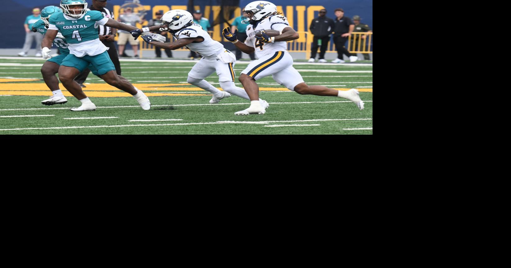 WVU football 0905 Cam Cook follows block front