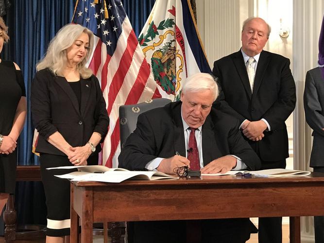 Justice signs bill providing pay raise for corrections WV News